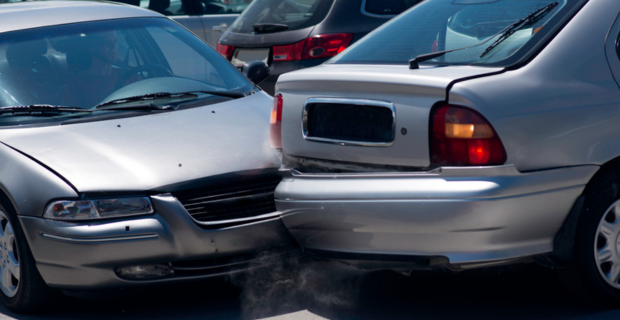 A car crashed into another car reversing out of a parking spot.