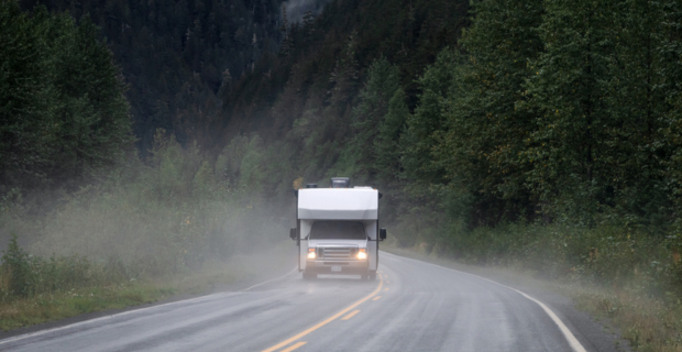 Motorhome travelling along a remote highway in northwestern British Columbia while it’s raining. 