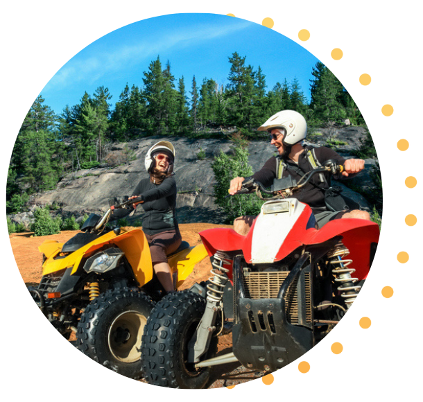 Two friends about to head out for a ride on their ATVs.
