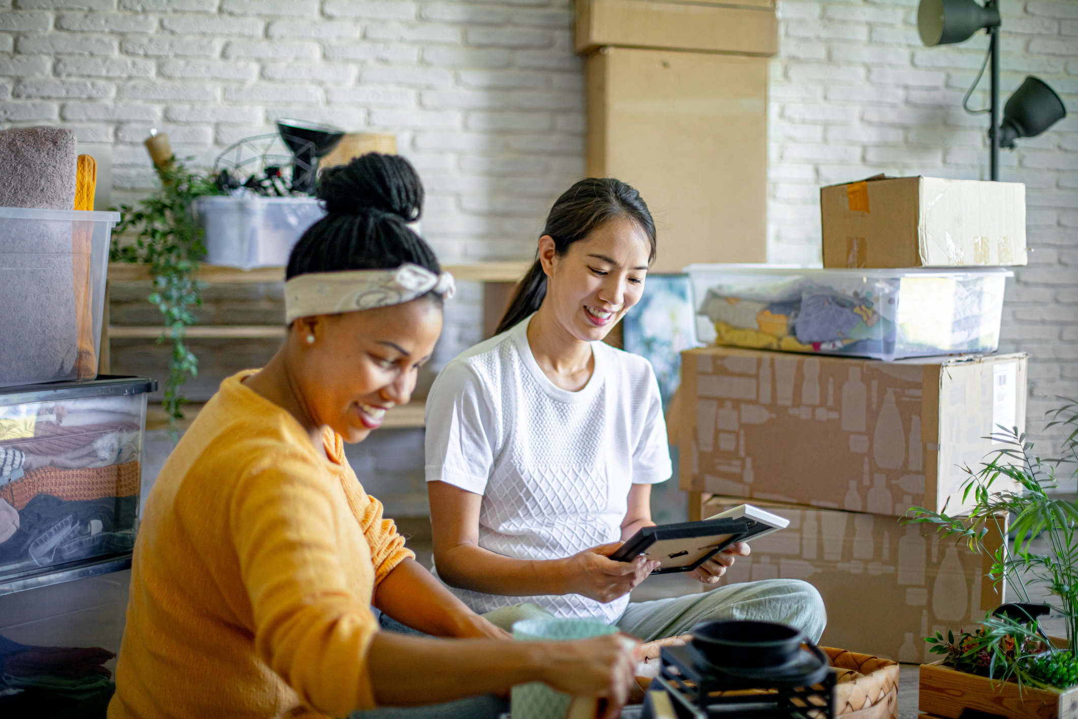 A smiling couple unpacking boxes in their new home