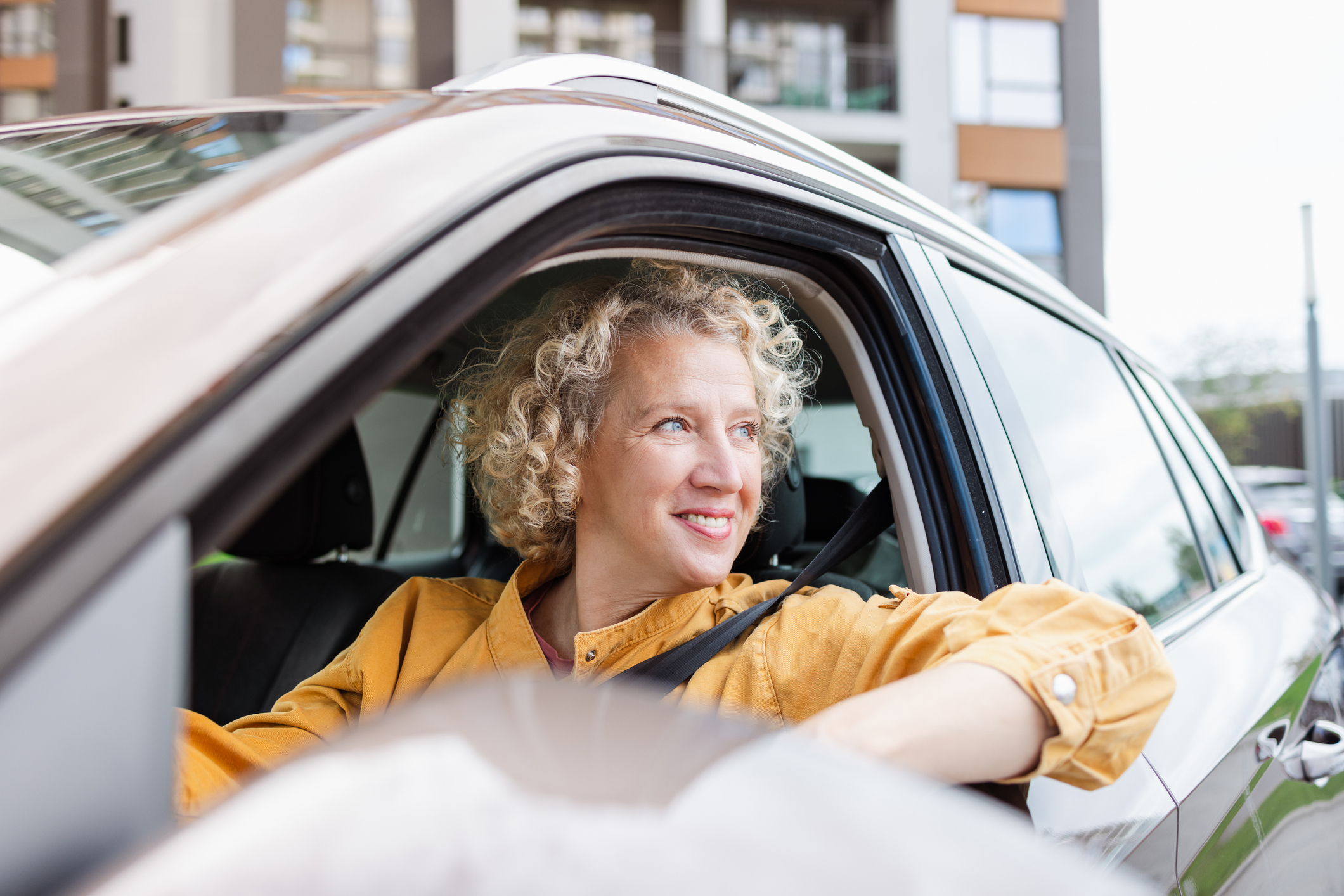 A woman looking out her car window