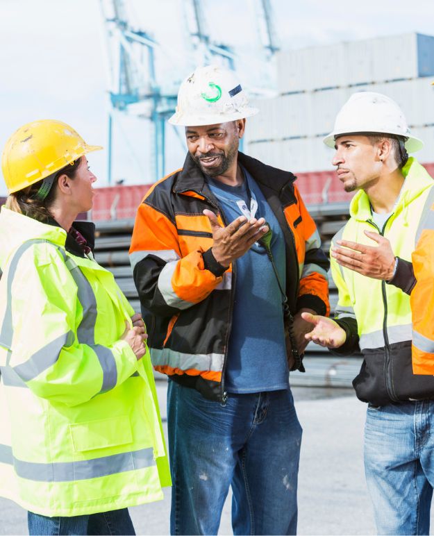 A group of construction workers in conversation.