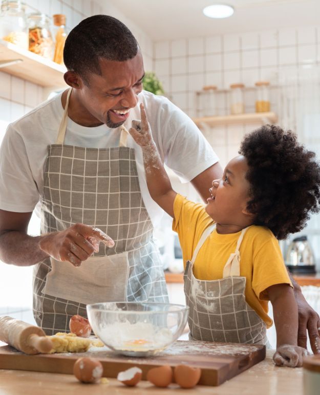 A father and child baking together in the kitchen.