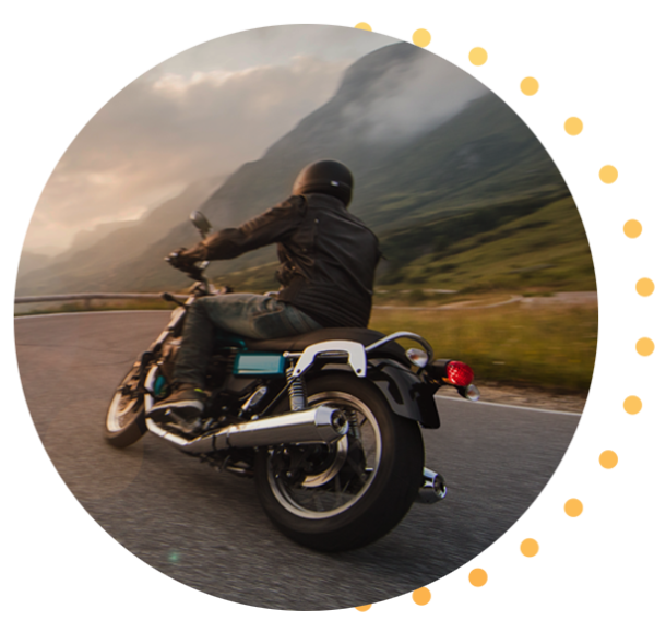 A rider on their bike, driving on a mountain road