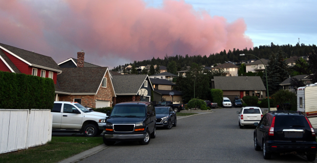A Canadian home surrounded by trees during heightened wildfire risk conditions.  