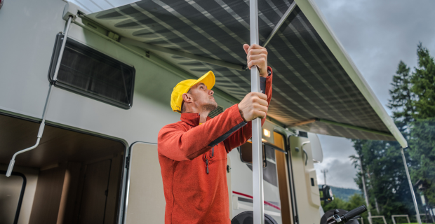 A person taking down their RV awning before a storm.  