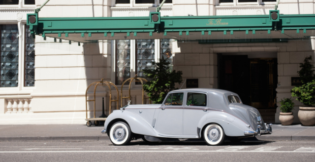 Vintage Rolls Royce Car parked in front of a hotel
