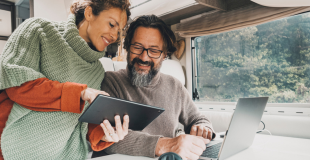 A couple looking at booking a campsite for the season ahead and getting ready for the RV season.